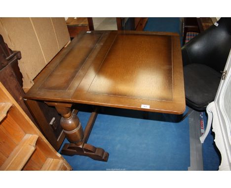 A drop leaf gate leg dining table on baluster legs joined by stretcher extends to 56" long x 38" wide.