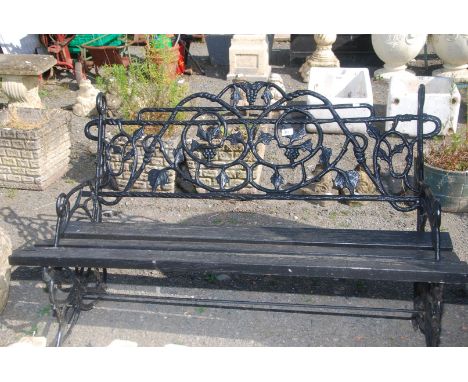 ****   A black painted cast iron garden Bench with leaf design, 48'' x 30''.[ A foot is missing ]