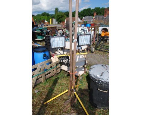 A tripod stand, 240 volt work lamp, two rakes and an edging spade.
