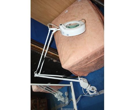 An adjustable magnifying lamp by L.T.S. with table fastening.