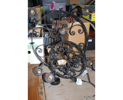A large and a small wrought iron chandelier (bayonette light bulb fittings).