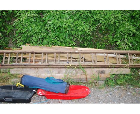 An 11 rung wooden extending ladder having cross section safety metal rods.
