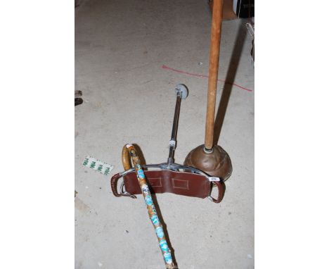 A shooting stick, a walking stick and a washing dolly.