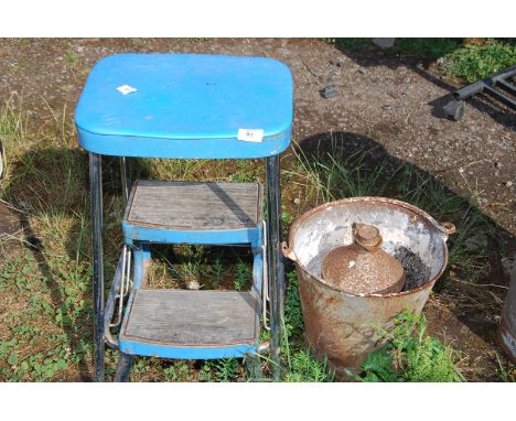 A galvanised pail, small fuel can and a step stool.