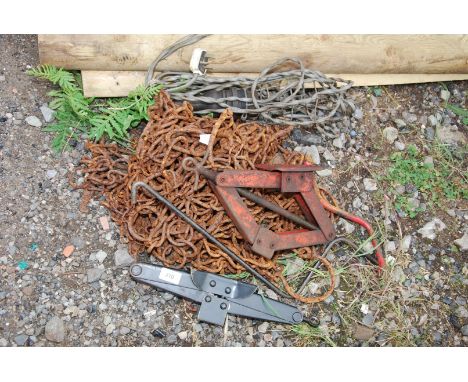 Old cow ties, vehicle screw jacks, chain and lead lamp.