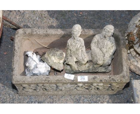A concrete planter and a hedgehog.