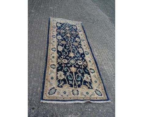 A blue ground Runner with cream ground border and contrasting cream, navy and light blue pattern, 74'' x 31''..