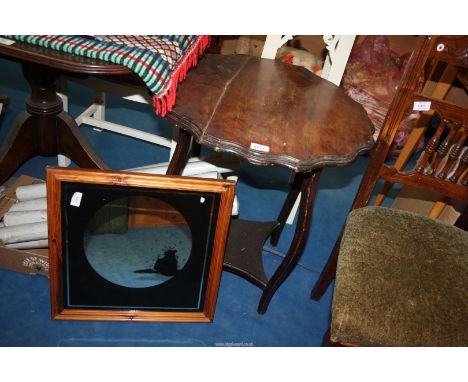 A scalloped edge occasional table with lower shelf and a picture mirror.