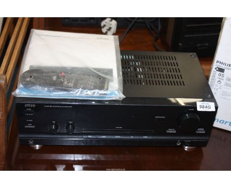 An Eltax Acura Amp - 70 integrated amplifier with remote and manual.