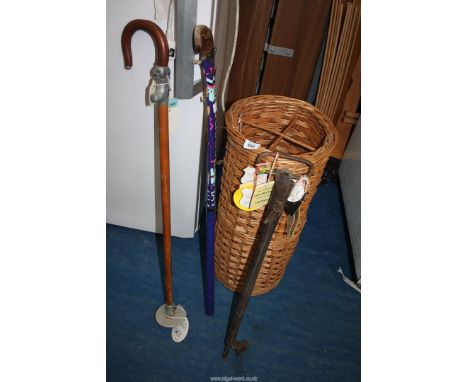 A wicker stick stand, shooting sticks with racing tags and hockey stick.