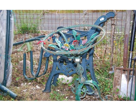 A pair of cast iron bench ends and a wrought iron table base, 19'' diameter x 27'' high.