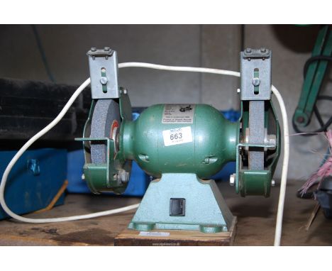 A 240 volt bench grinder, no safety visors or guards.