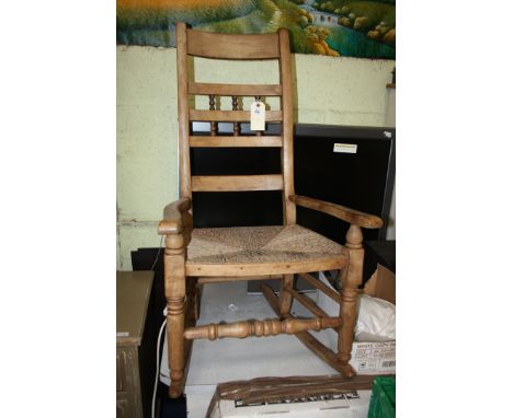 A ladder back rocking chair with rush seat.