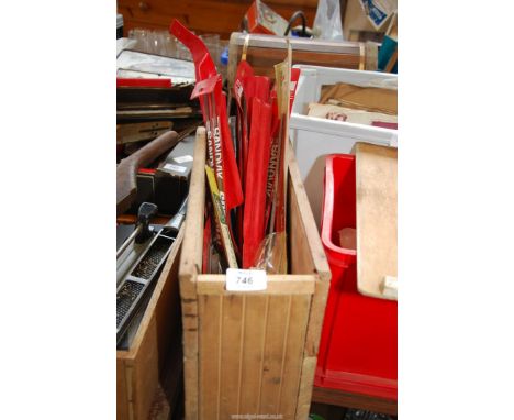 A wooden box containing chainsaw files.