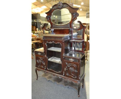 A late 19th to early 20th Century ebonised mahogany mirrored back side cabinet in the Chippendale style, with central cartouc