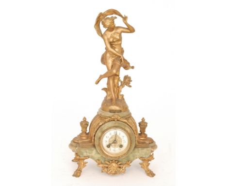 An early 20th Century Art Nouveau spelter mantle clock modelled as a maiden holding a scarf on an onyx base with eight day st