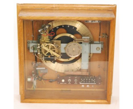 A post war factory/office slave clock by the Synchronome Co Ltd, type DR PC, fifty cycles with brass dial and day dial in oak