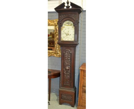 A 19th Century carved oak longcase clock with an eight day movement, the 13 inch painted broken arch dial with subsidiary sec