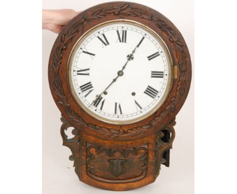 A late Victorian oak cased drop dial circular wall clock, with a later dial and applied oak leaf decoration, height 60cm