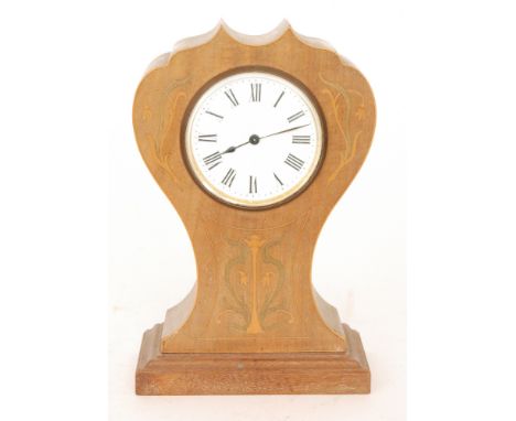 An Art Nouveau French mantle clock, Roman numerals to a shaped wooden case with inlaid and stained foliate scroll decoration,