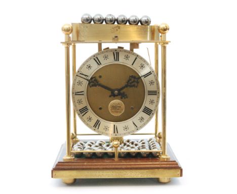 A later 20th Century Thwaites Reed lacquered brass spheroid weight clock, Roman numerals to a silvered chapter ring all to a 