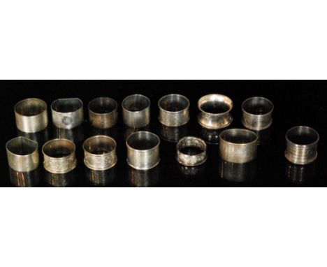 Fourteen assorted hallmarked silver napkin rings to include engine turned and foliate engraved examples, total weight approxi