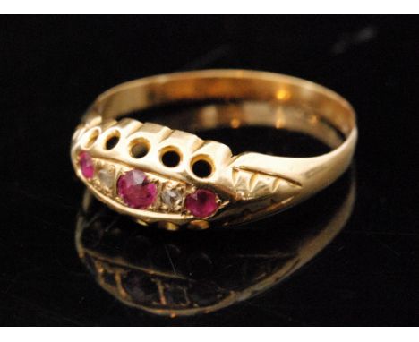 An 18ct hallmarked ruby and diamond five stone boat shaped ring, claw set stones to a plain tapering shank, Birmingham 1917, 