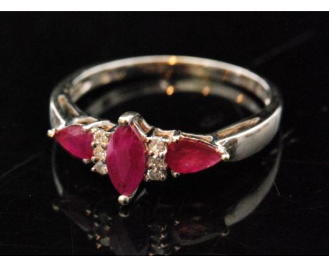 A modern 9ct white gold ruby and diamond ring central marquise ruby flanked by three diamond, in turn flanked by a further pe