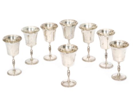 A composed set of eight hallmarked silver goblets each with circular stepped foot below plain flaring bowls, total weight 35.