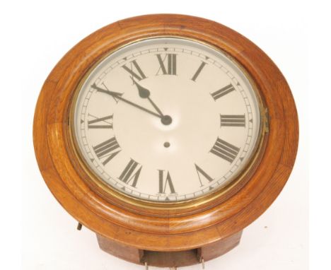 An early 20th Century circular oak wall clock with painted dial and spring driven movement, diameter 44cm