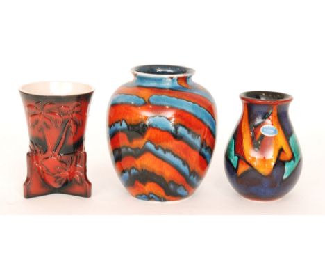 A contemporary Anita Harris Studio vase decorated in a striped red and blue glaze, printed mark and painted in gold AH Trial,