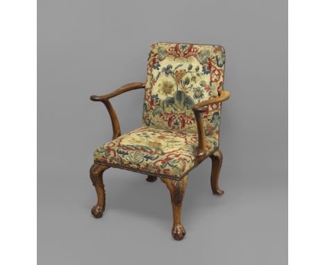 A GEORGE II STYLE WALNUT ARMCHAIR, with tapestry covered seat and back and scrolling arms, the back legs with acanthus leaf c