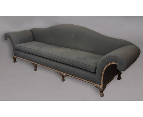A LARGE UPHOLSTERED SCROLL END SOFA, the camel back above one single long seat cushion, the frames with rows of metal studs o