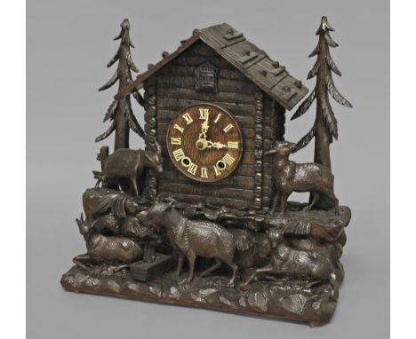 A BLACK FOREST CUCKOO CLOCK, the 5" wooden dial with Roman numerals on a brass eight day two train movement striking half hou