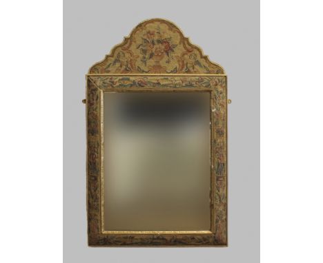 A STUMPWORK FRAMED CUSHION MIRROR, the shaped pediment decorated with flowers and scrolling foliage above a bevelled mirror p