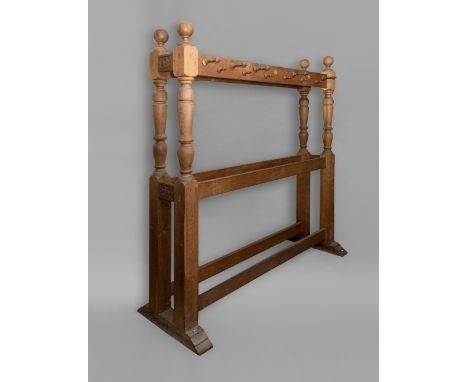 A COUNTRY HOUSE COAT STAND, the rails with two rows of turned pegs to each side, on turned pillars with ball finials, the bas