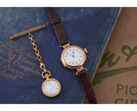A vintage 9ct gold cased lady's wristwatch and a gold plated nurse's watch on a 9ct gold support, the watch running but some 