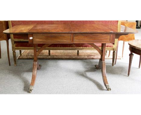 A Reproduction Drop Leaf Mahogany Sofa Table, with brass paw feet, moving on castors, 150cm by 68cm by 71cm