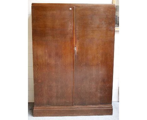 A 1940s Oak Gentlemans Compactom Wardrobe, 122cm by 51cm by 173cm   General light wear and scuffs. Some very small veneer chi