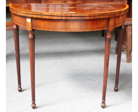 A George IV Mahogany Fold Over Card Table, with inlaid shell patera, crossbanded in satinwood and on reeded tapering supports