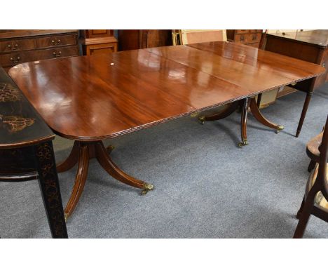 A Reproduction Mahogany Twin Pillar Dining Table, with two additional leaves, 230cm by 122cm by 76cm