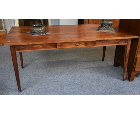 A French Cherrywood Farmhouse Table, 169cm by 82cm by 72cm.Slight plank speration and minor splits, light wood worm damage. S