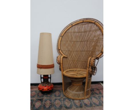 A mid Century cane peacock chair of good size, together with a German pottery floor lamp with original shade