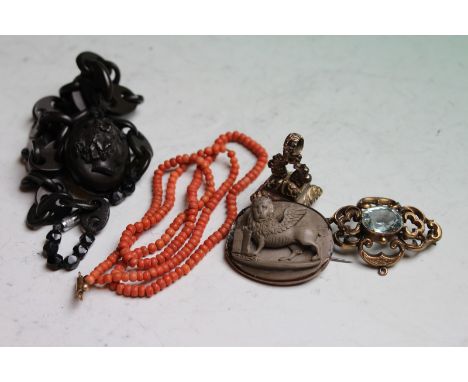 A Victorian vulcanite memorial locket on chain link necklace, a child's coral necklace, a lava cameo brooch, seal and a pierc