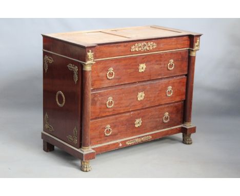 A mahogany ormolu mounted commode in the French Empire style, the column pilasters flanking four long drawers, on paw feet, (