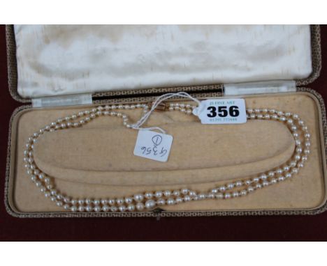 A two row cultured pearl necklace with 9ct gold clasp, (boxed)
