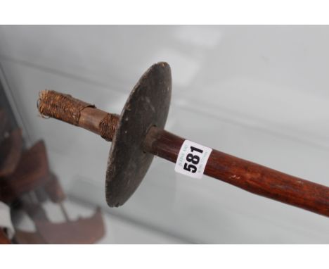 An interesting, possibly Polynesian, tribal club with scratch decorated shaft and slate disc head, together with a blow pipe