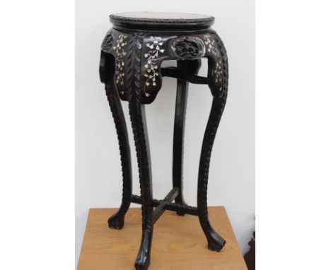 A Chinese carved hardwood urn stand, with marble inset top and inlaid mother of pearl decoration, 94cm high, (top 38cm diamet