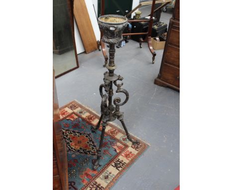 A Victorian cast iron oil lamp stand, on shaped tri-form supports