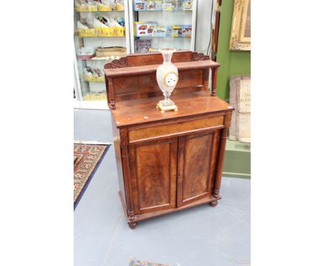 A William IV mahogany chiffonier, the raised shelf with turned supports above frieze drawer and two panel doors flanked by co